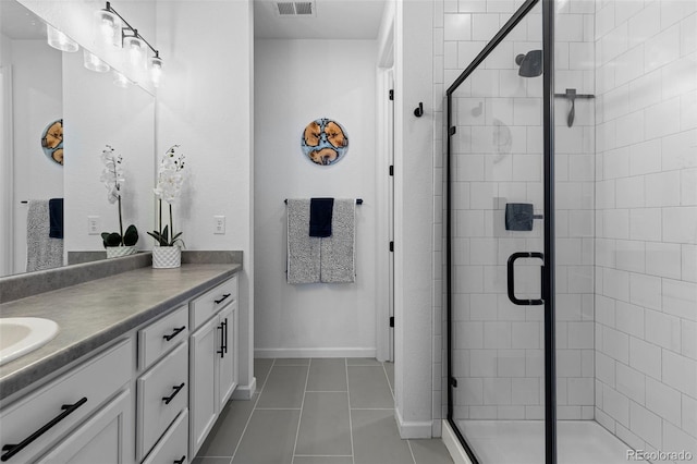 bathroom with vanity, tile patterned floors, and a shower with shower door