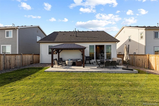 rear view of property with a gazebo, a yard, a patio area, and an outdoor hangout area