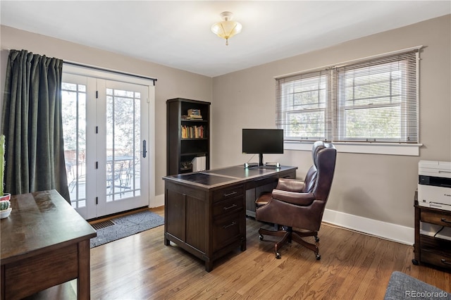 office area with light wood finished floors and baseboards