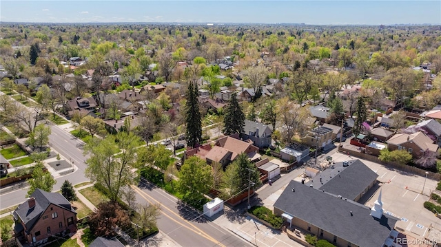 drone / aerial view featuring a forest view and a residential view