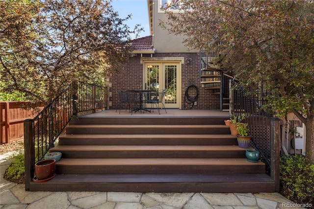 deck featuring stairway and fence