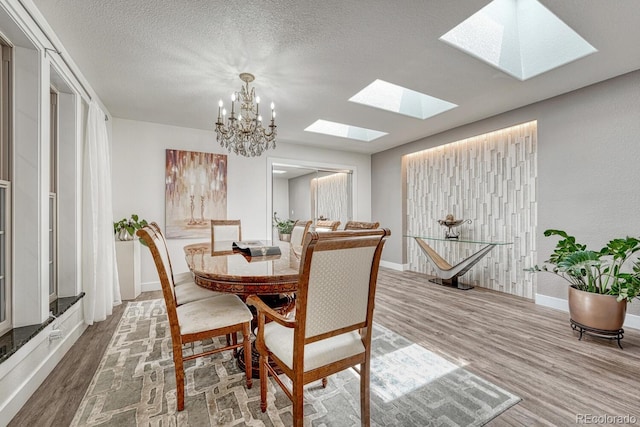 5173 S Emporia Way, Greenwood Village, CO 80111 - dining area featuring a skylight, wood finished floors, a chandelier, and a textured ceiling