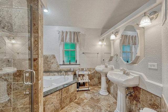 5173 S Emporia Way, Greenwood Village, CO 80111 - full bathroom featuring a bath, a stall shower, and a textured wall