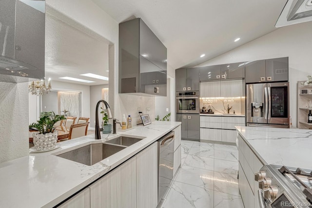 5173 S Emporia Way, Greenwood Village, CO 80111 - kitchen with appliances with stainless steel finishes, gray cabinetry, modern cabinets, light marble finish flooring, and lofted ceiling