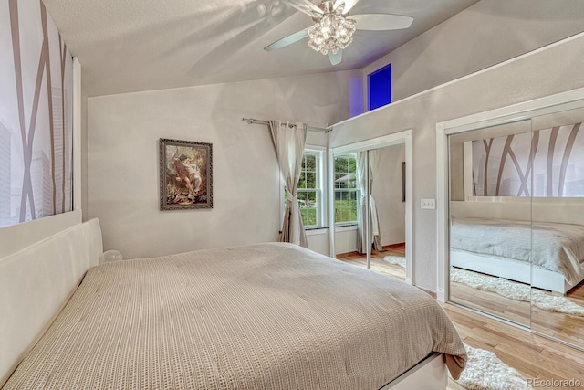 5173 S Emporia Way, Greenwood Village, CO 80111 - bedroom featuring vaulted ceiling, wood finished floors, multiple closets, and a ceiling fan