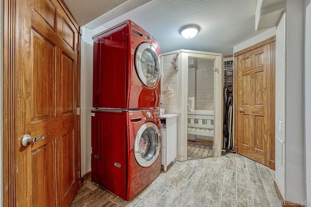 5173 S Emporia Way, Greenwood Village, CO 80111 - laundry area with estacked washer and dryer, wood finished floors, and a textured ceiling