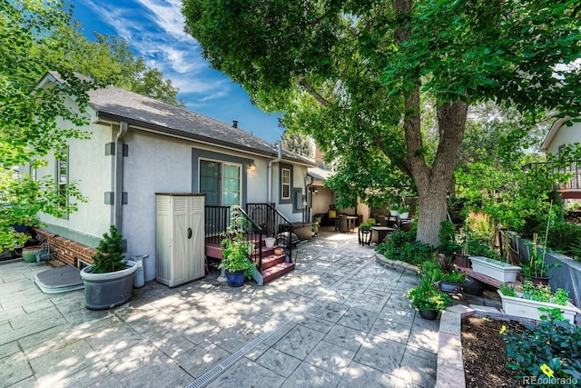 5173 S Emporia Way, Greenwood Village, CO 80111 - back of property featuring a patio, stucco siding, and a garden