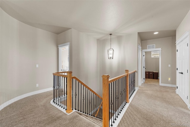 corridor with light colored carpet