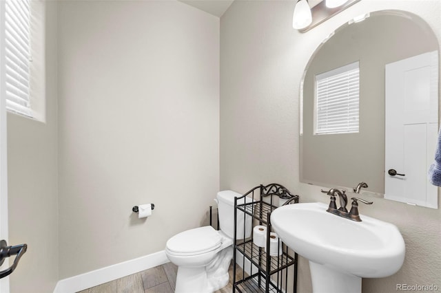 bathroom featuring hardwood / wood-style floors, sink, and toilet