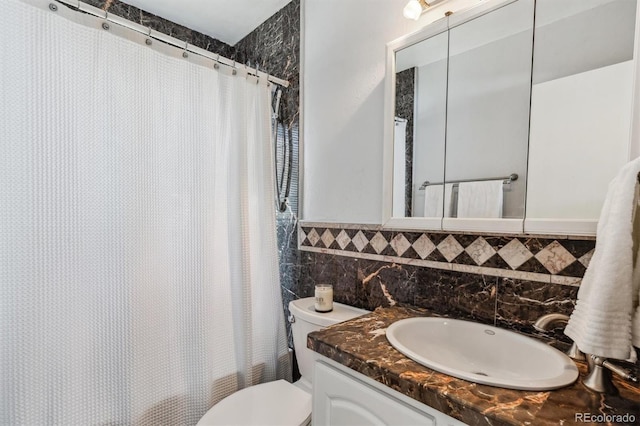 full bathroom featuring vanity, toilet, tile walls, and shower / tub combo