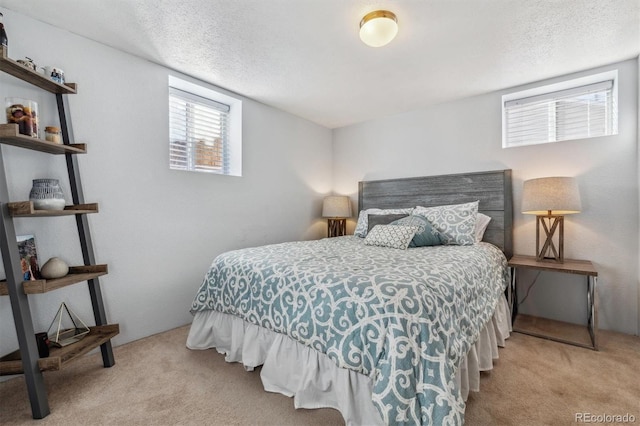 carpeted bedroom featuring a textured ceiling