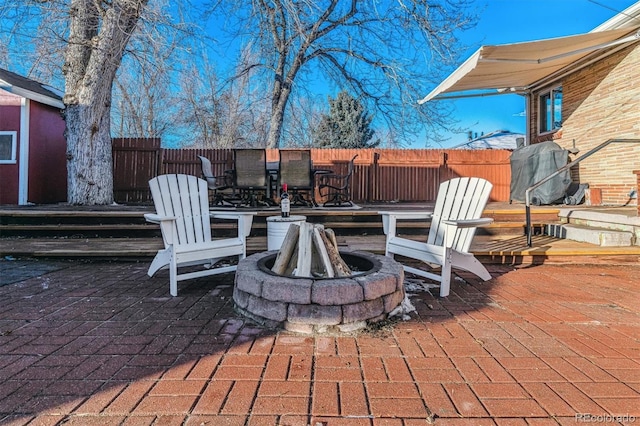 view of patio / terrace with an outdoor fire pit and a grill