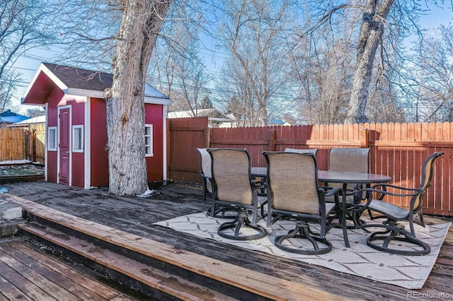 wooden terrace featuring a storage shed