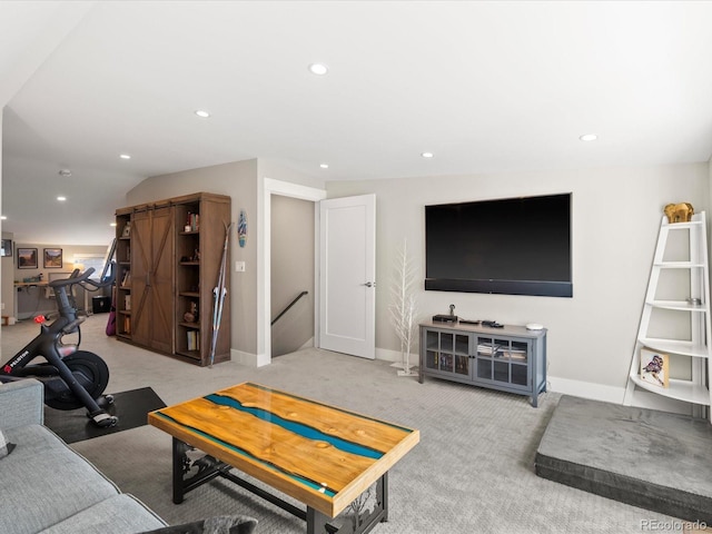 living room with lofted ceiling and light colored carpet