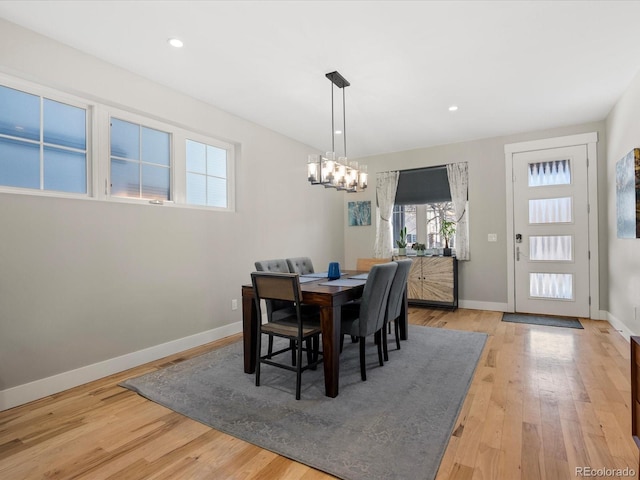 dining space with a chandelier and light wood-type flooring