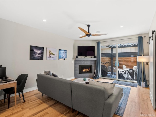 living room featuring ceiling fan and hardwood / wood-style floors