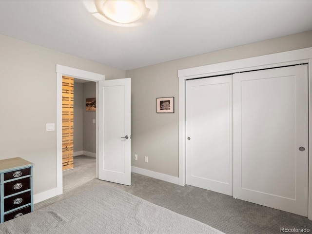 unfurnished bedroom with light colored carpet and a closet