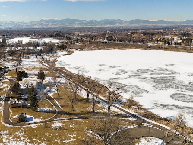 snowy aerial view with a mountain view