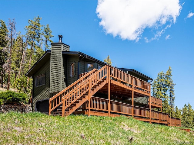 34075 Grouse Ln, Evergreen, CO 80439 - back of house with a deck and a chimney