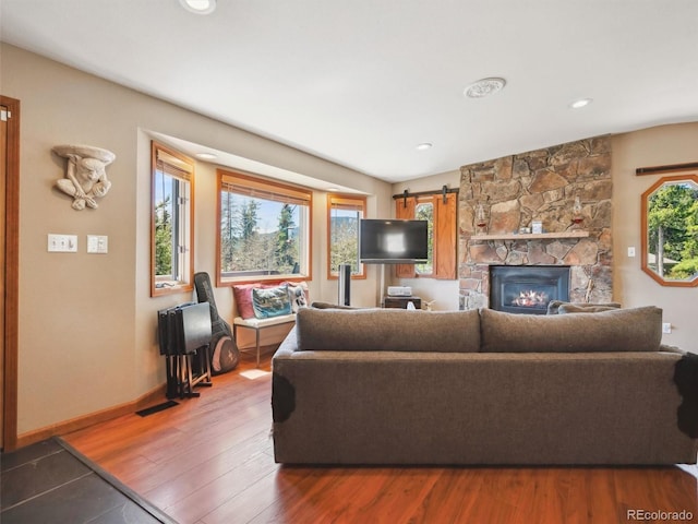 34075 Grouse Ln, Evergreen, CO 80439 - living room with wood finished floors, a fireplace, baseboards, and recessed lighting