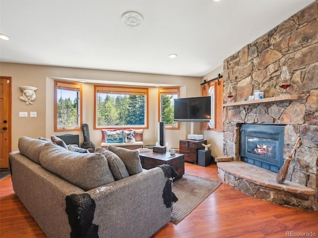 34075 Grouse Ln, Evergreen, CO 80439 - living area featuring wood finished floors, recessed lighting, and a stone fireplace