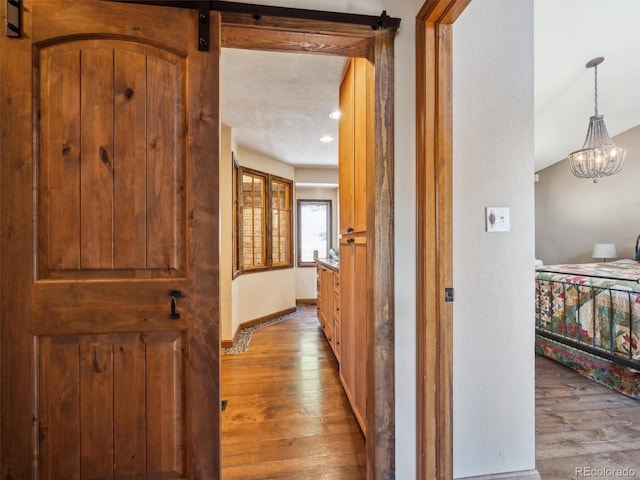 34075 Grouse Ln, Evergreen, CO 80439 - hall with hardwood / wood-style floors, a chandelier, and baseboards