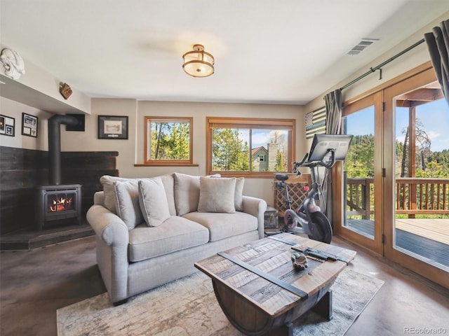34075 Grouse Ln, Evergreen, CO 80439 - living area featuring concrete flooring and a wood stove