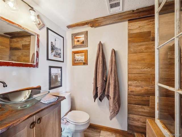 34075 Grouse Ln, Evergreen, CO 80439 - bathroom with toilet, vanity, and baseboards