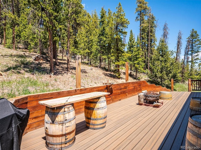 34075 Grouse Ln, Evergreen, CO 80439 - wooden deck featuring an outdoor fire pit and area for grilling