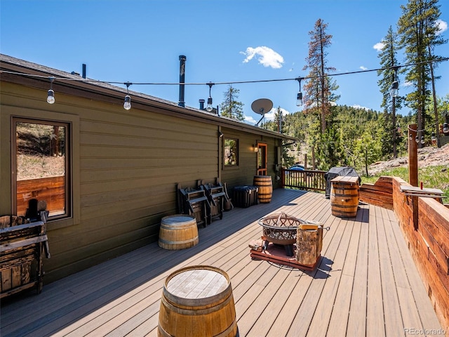34075 Grouse Ln, Evergreen, CO 80439 - wooden deck with a fire pit