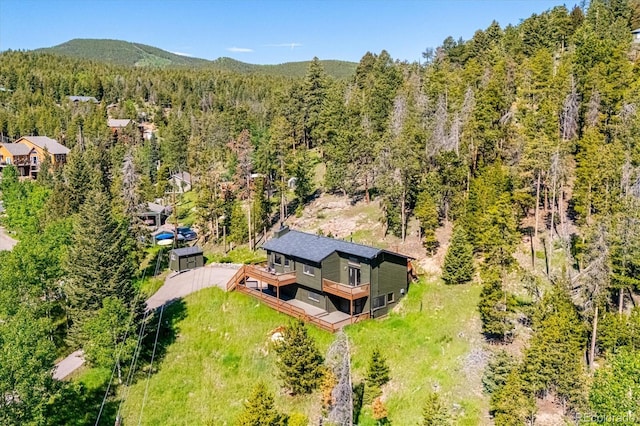 34075 Grouse Ln, Evergreen, CO 80439 - aerial view of property and surrounding area featuring a heavily wooded area and mountains