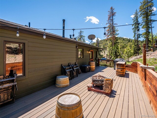 34075 Grouse Ln, Evergreen, CO 80439 - deck with an outdoor fire pit and area for grilling