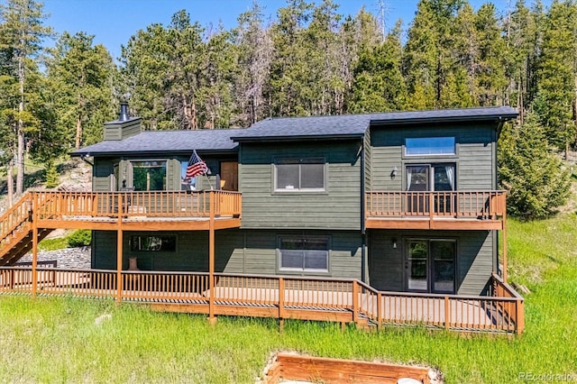 34075 Grouse Ln, Evergreen, CO 80439 - view of front of property featuring a balcony, a chimney, and a wooden deck