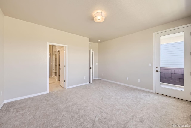 carpeted spare room featuring baseboards