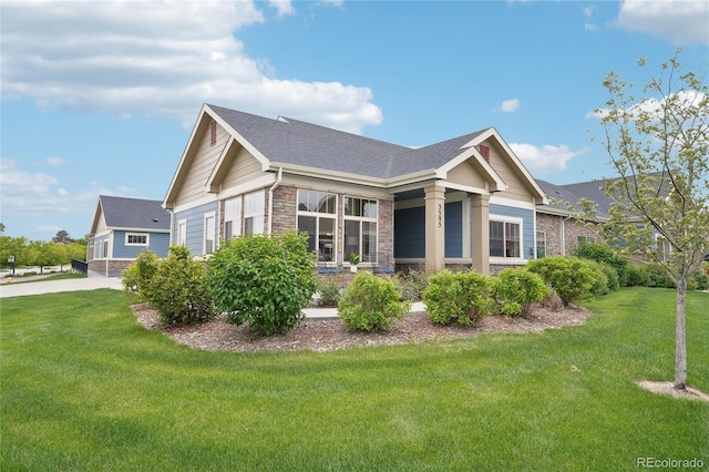 3595 E 124th Pl, Thornton, CO 80241 - view of home's exterior with stone siding, a lawn, and roof with shingles