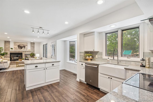 13701 Yank Way, Arvada, CO 80004 - kitchen with stainless steel dishwasher, decorative backsplash, healthy amount of natural light, and recessed lighting