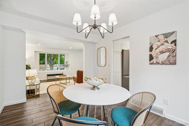 13701 Yank Way, Arvada, CO 80004 - dining area featuring wood finished floors and a chandelier