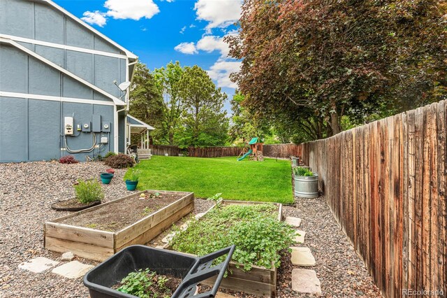 13701 Yank Way, Arvada, CO 80004 - fenced backyard with a playground and a garden