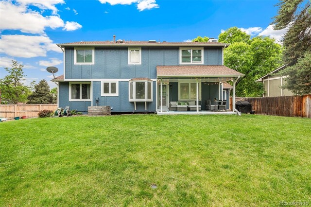 13701 Yank Way, Arvada, CO 80004 - back of property featuring a fenced backyard and a patio area