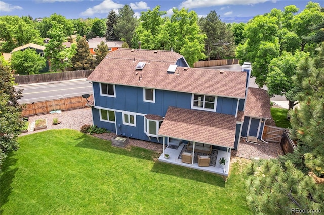 13701 Yank Way, Arvada, CO 80004 - rear view of property featuring a shingled roof, a fenced backyard, a patio area, and board and batten siding