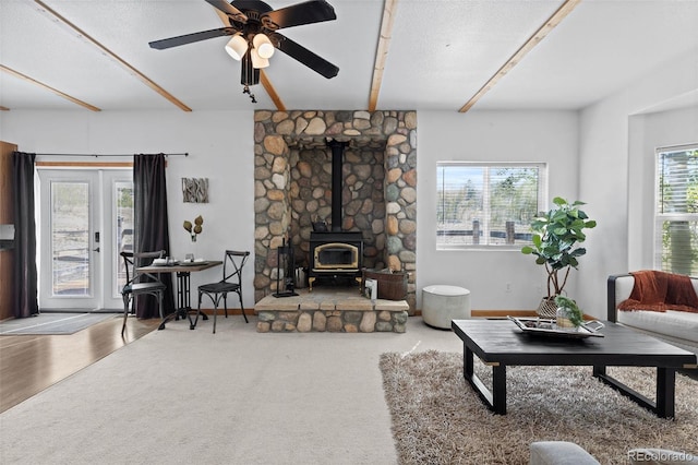 7551 Remington Rd, Como, CO 80432 - living area featuring a wood stove, beamed ceiling, and a ceiling fan