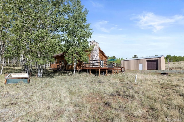 7551 Remington Rd, Como, CO 80432 - view of yard with an outdoor structure, a wooden deck, and a detached garage