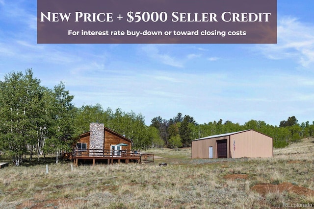 7551 Remington Rd, Como, CO 80432 - view of yard featuring a garage, an outbuilding, and a deck