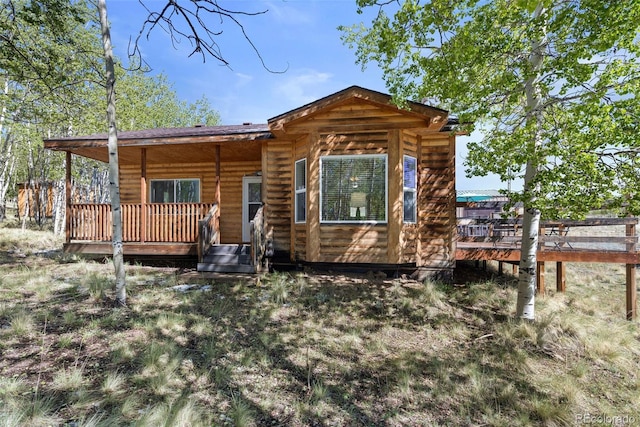 7551 Remington Rd, Como, CO 80432 - view of front of home featuring a wooden deck and faux log siding