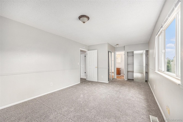 16835 E Harvard Pl, Aurora, CO 80013 - unfurnished bedroom with carpet, a textured ceiling, and ensuite bathroom