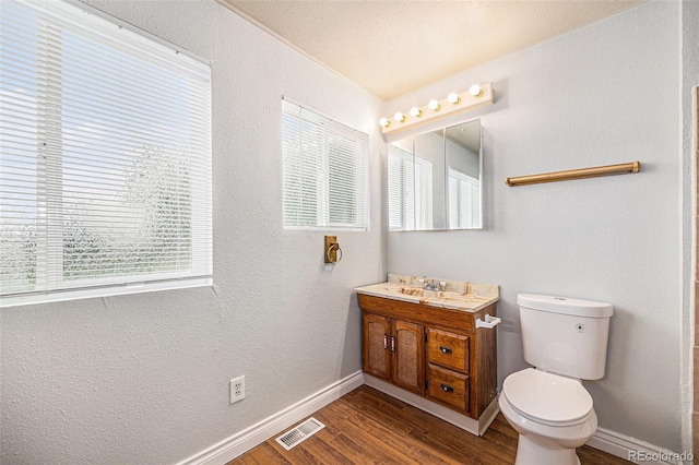 16835 E Harvard Pl, Aurora, CO 80013 - bathroom featuring vanity, wood finished floors, and a textured wall