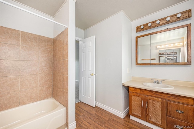 16835 E Harvard Pl, Aurora, CO 80013 - bathroom featuring wood finished floors, vanity, and washtub / shower combination