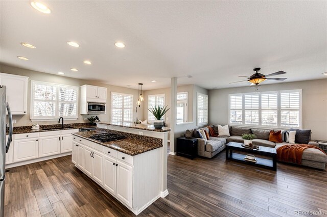 4968 Montvale Dr, Highlands Ranch, CO 80130 - kitchen featuring open floor plan, a center island, appliances with stainless steel finishes, and a healthy amount of sunlight