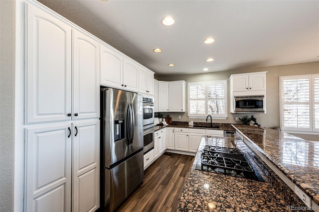 4968 Montvale Dr, Highlands Ranch, CO 80130 - kitchen featuring a sink, dark wood-style flooring, appliances with stainless steel finishes, white cabinetry, and recessed lighting