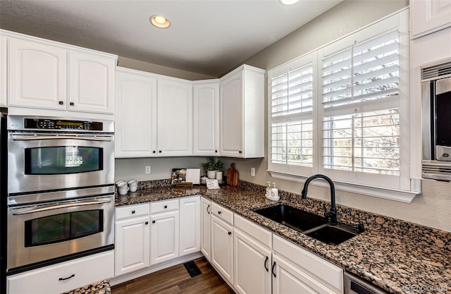 4968 Montvale Dr, Highlands Ranch, CO 80130 - kitchen featuring white cabinets, recessed lighting, a sink, and appliances with stainless steel finishes